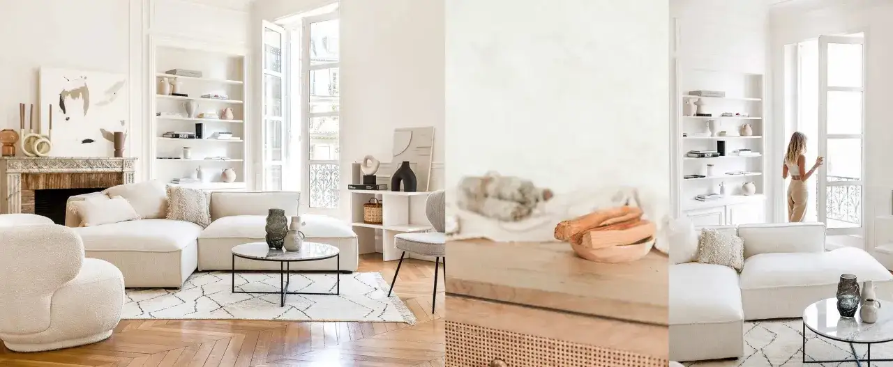 Un salon salle &agrave; manger moderne et &eacute;pur&eacute;, avec un canap&eacute; blanc, une chemin&eacute;e en marbre et des &eacute;tag&egrave;res remplies d'objets d&eacute;coratifs.