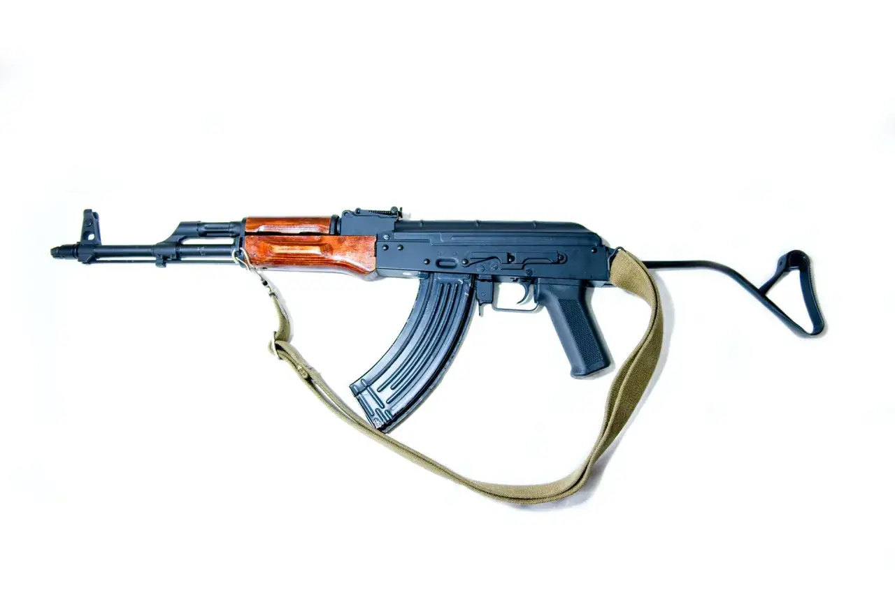 Karabin AK-47 z drewnianą kolbą i pasem. Zastanawiasz się, jak odzyskać cofnięte pozwolenie na broń?