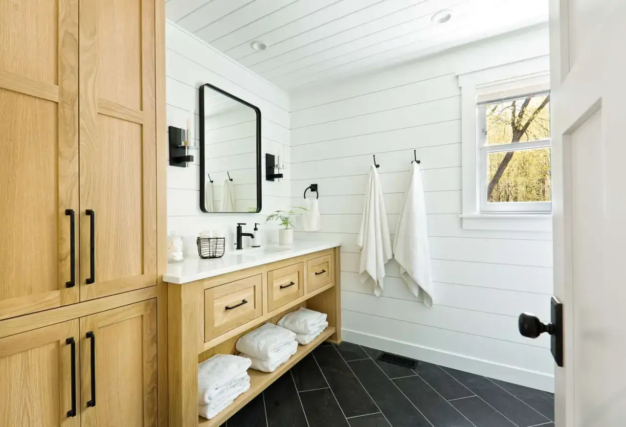 Natural wood cabinets offer a warm, inviting look, proving they are the best color for bathroom cabinets.