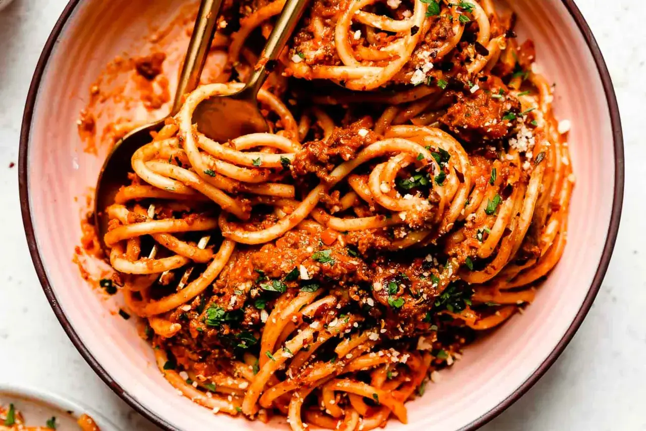 Pyszne spaghetti bolognese, idealne na prosty obiad. Makaron z bogatym sosem mięsnym i posypką z parmezanu.