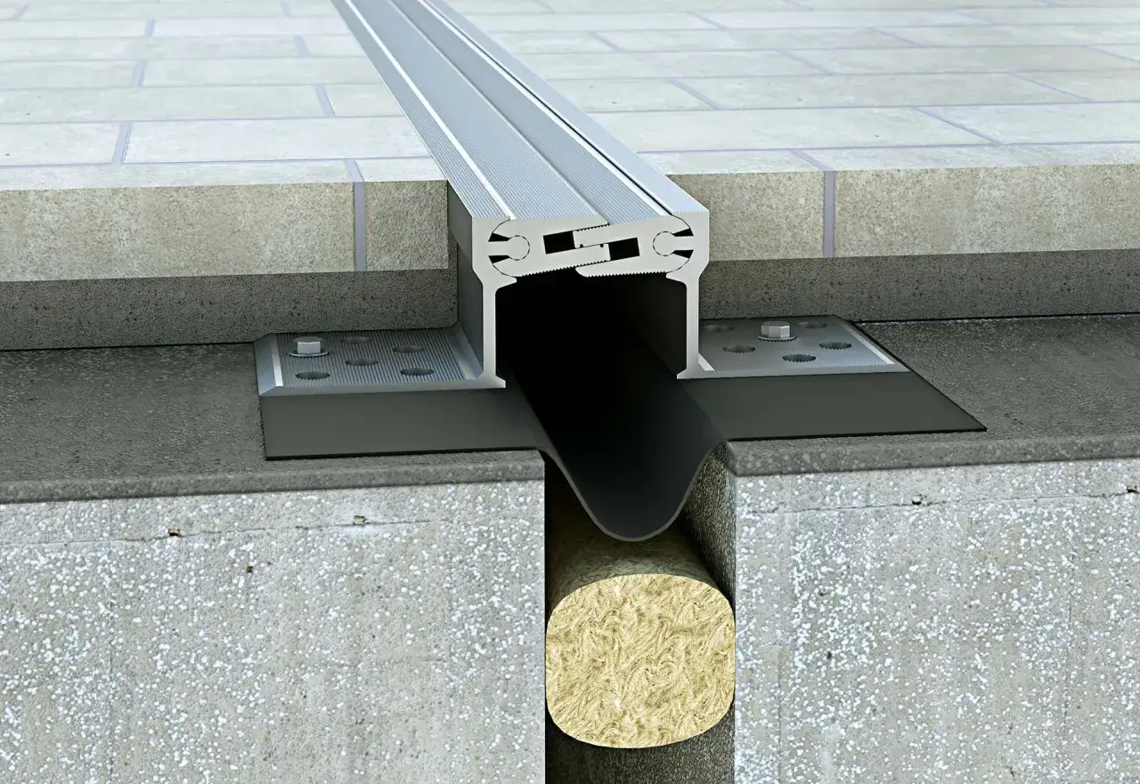 Detalle de junta de dilatación para edificios, mostrando el perfil de aluminio, la membrana y el aislamiento.