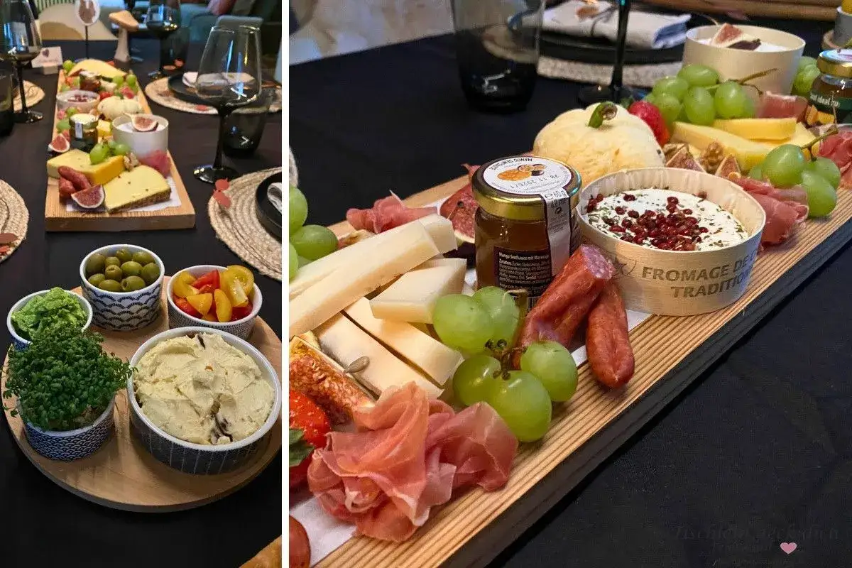 Ein köstlicher weinabend mit freunden: Käse, Trauben, Feigen, Aufschnitt und Dips auf einer Holzplatte.