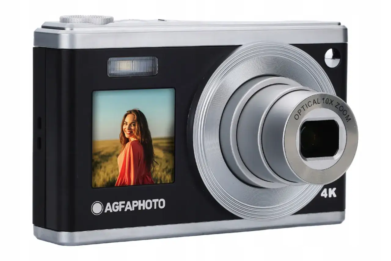Aparat AGFAPHOTO z optycznym zoomem 10x. Na ekranie zdjęcie uśmiechniętej kobiety w sukience.