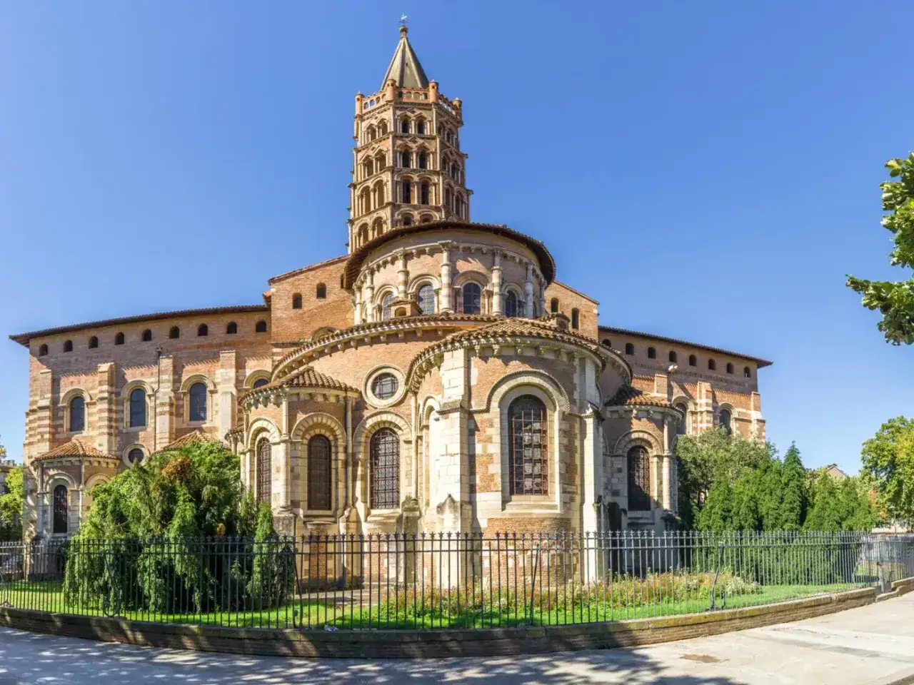 La basilique Saint-Sernin, joyau de l'art roman, se dresse fi&egrave;rement sous un ciel bleu. Un aper&ccedil;u de la beaut&eacute; de Toulouse et ses environs.