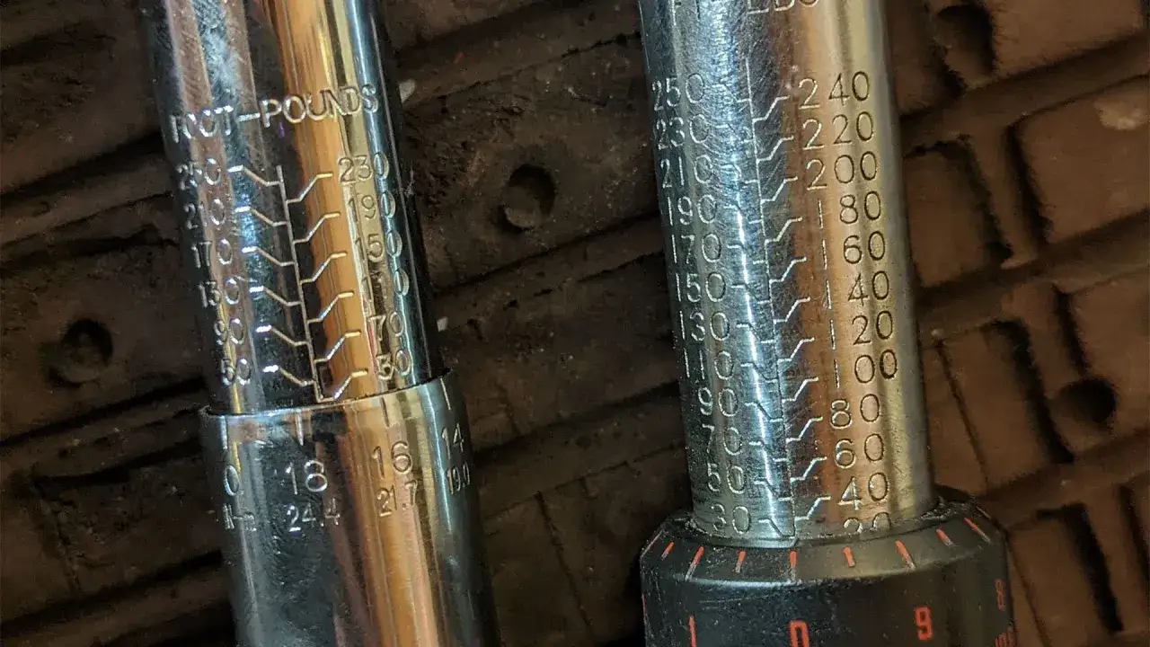 Two torque wrenches with clear markings for foot-pounds, showing how to use a torque wrench to achieve precise tightening.