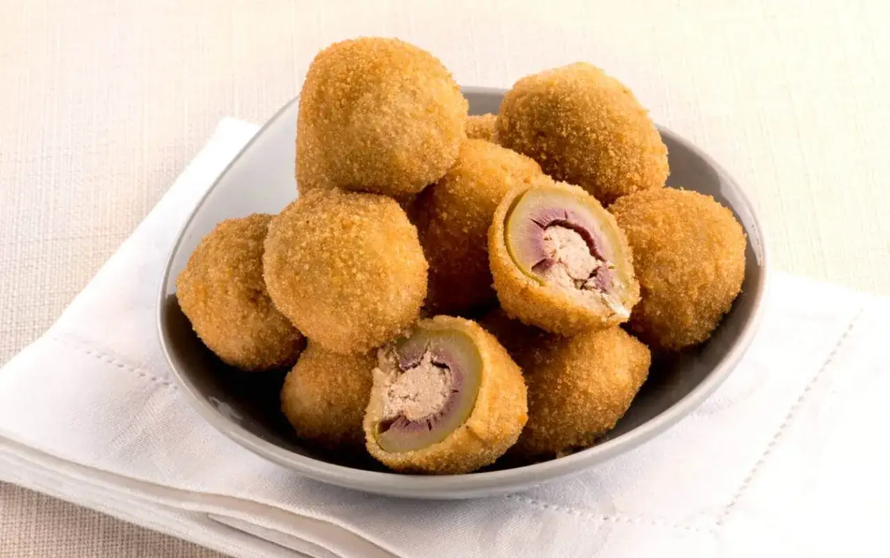 Piatto di olive ascolane fritte, croccanti fuori e ripiene di carne saporita. La ricetta perfetta per un antipasto gustoso.