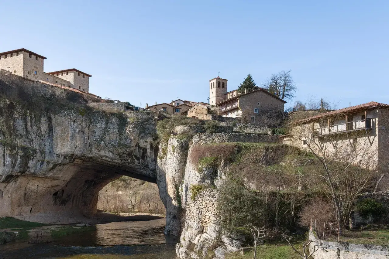 Pueblo con casas de piedra sobre un arco natural en el r&iacute;o. Descubre c&oacute;mo llegar a este puente de ensue&ntilde;o.