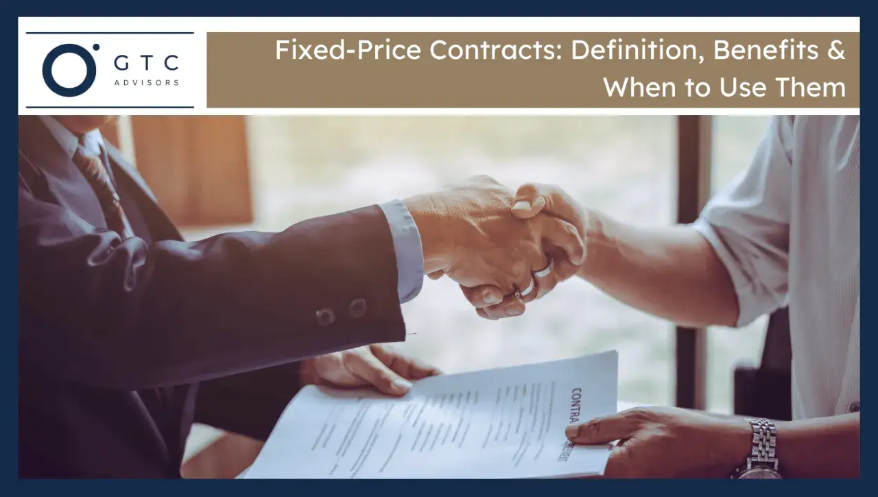 Two businessmen shake hands over a contract, signifying a firm fixed contract.