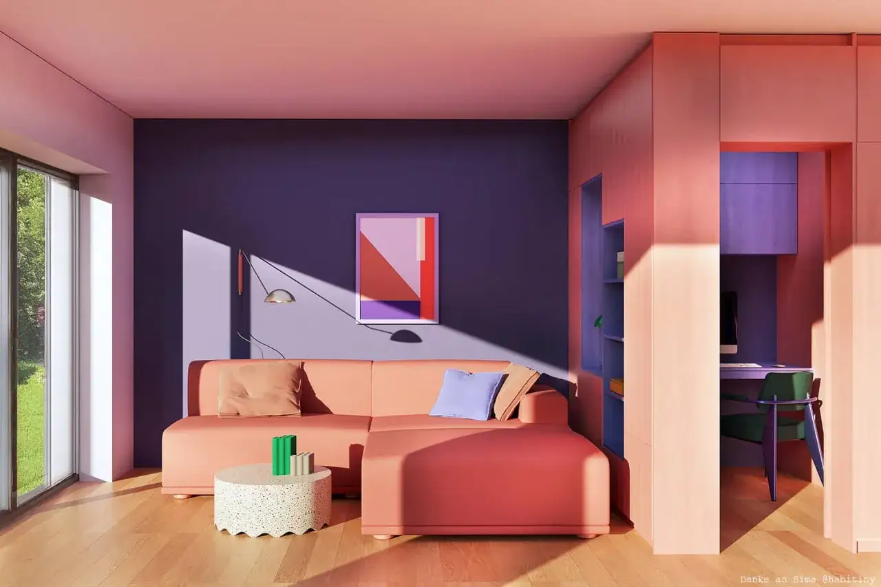 Ein Wohnzimmer, in dem sich Rosa und Lila harmonisch mischen. Ein Korallsofa steht vor einer violetten Wand, daneben ein Schreibtisch in Lila.