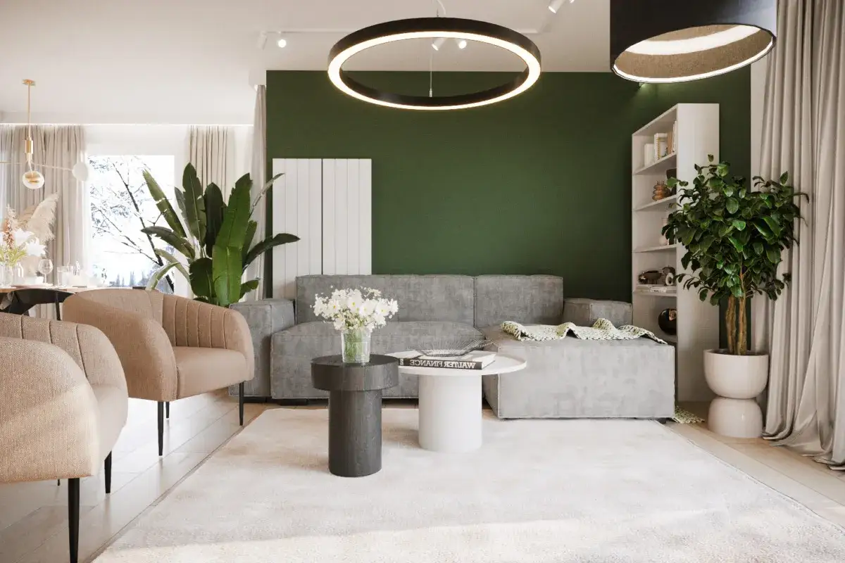 Nowoczesny salon z szarą sofą i fotelami. Zielona ściana z roślinami w domu dodaje świeżości.