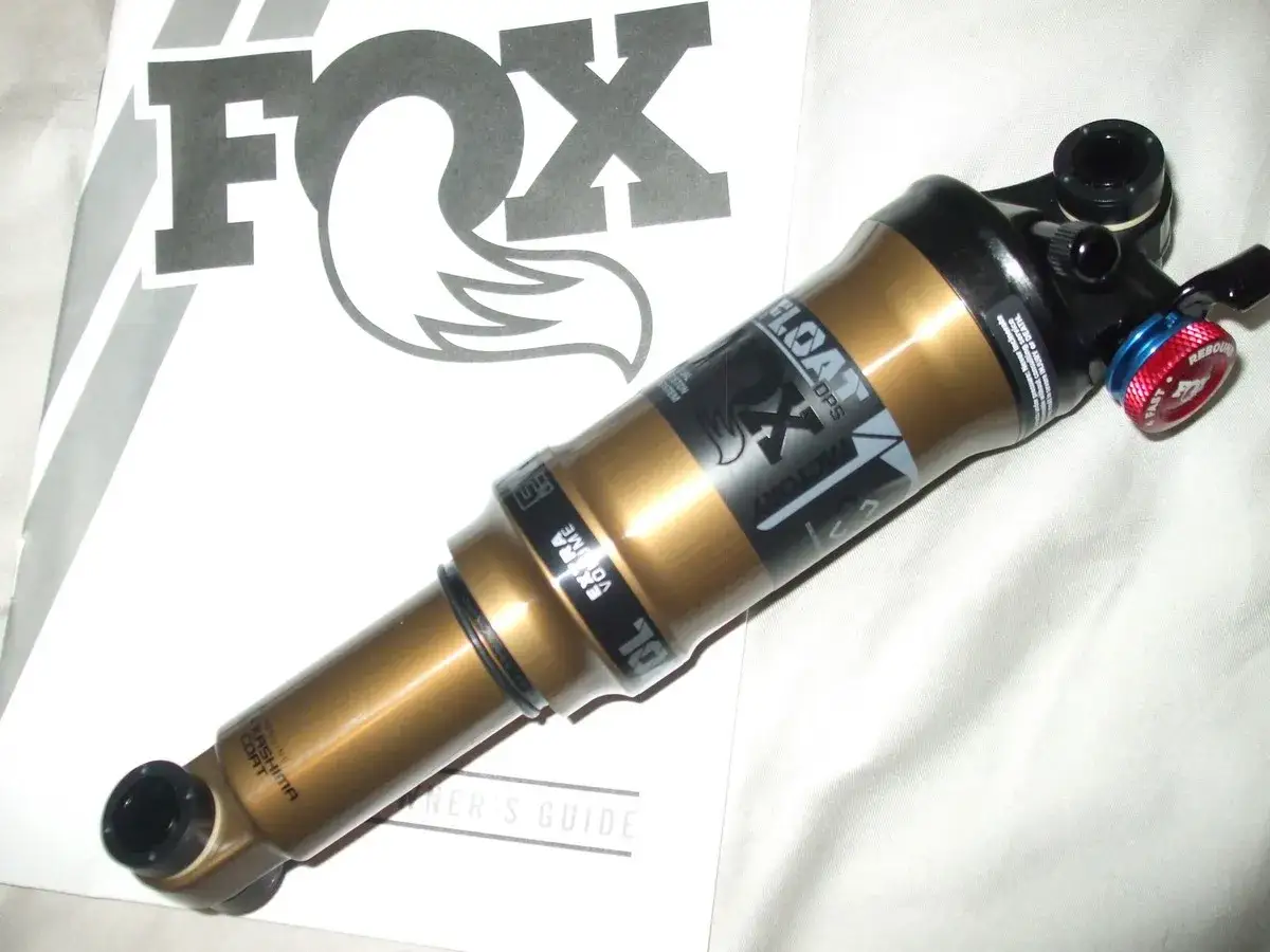 A gold Fox Float DPS Factory rear shock, ready for a bike build.