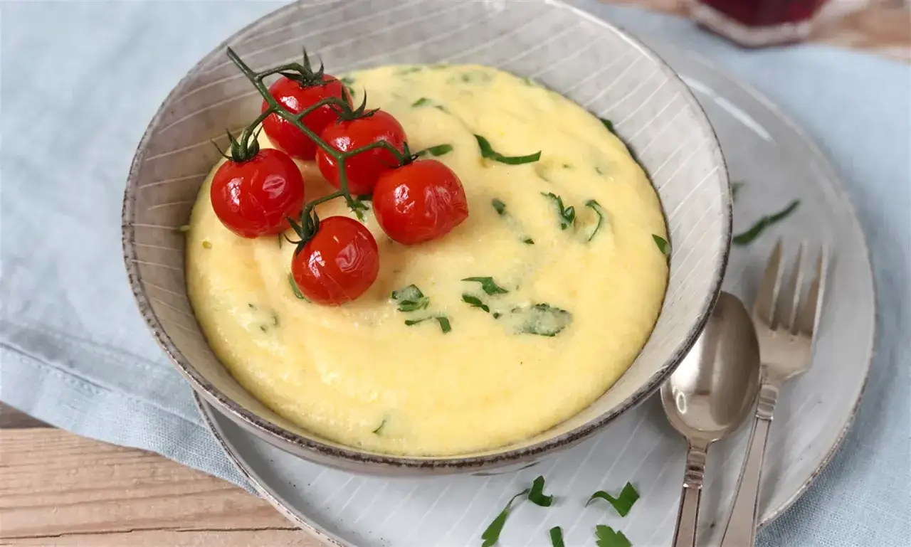 Cremige Polenta, perfekt gekocht, garniert mit Kirschtomaten und frischer Petersilie. Ein Genuss!
