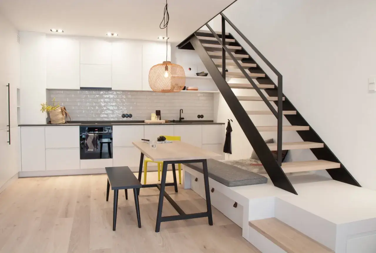 Moderne K&uuml;che und Essbereich einer Maisonette Wohnung einrichten. Eine Treppe f&uuml;hrt nach oben.