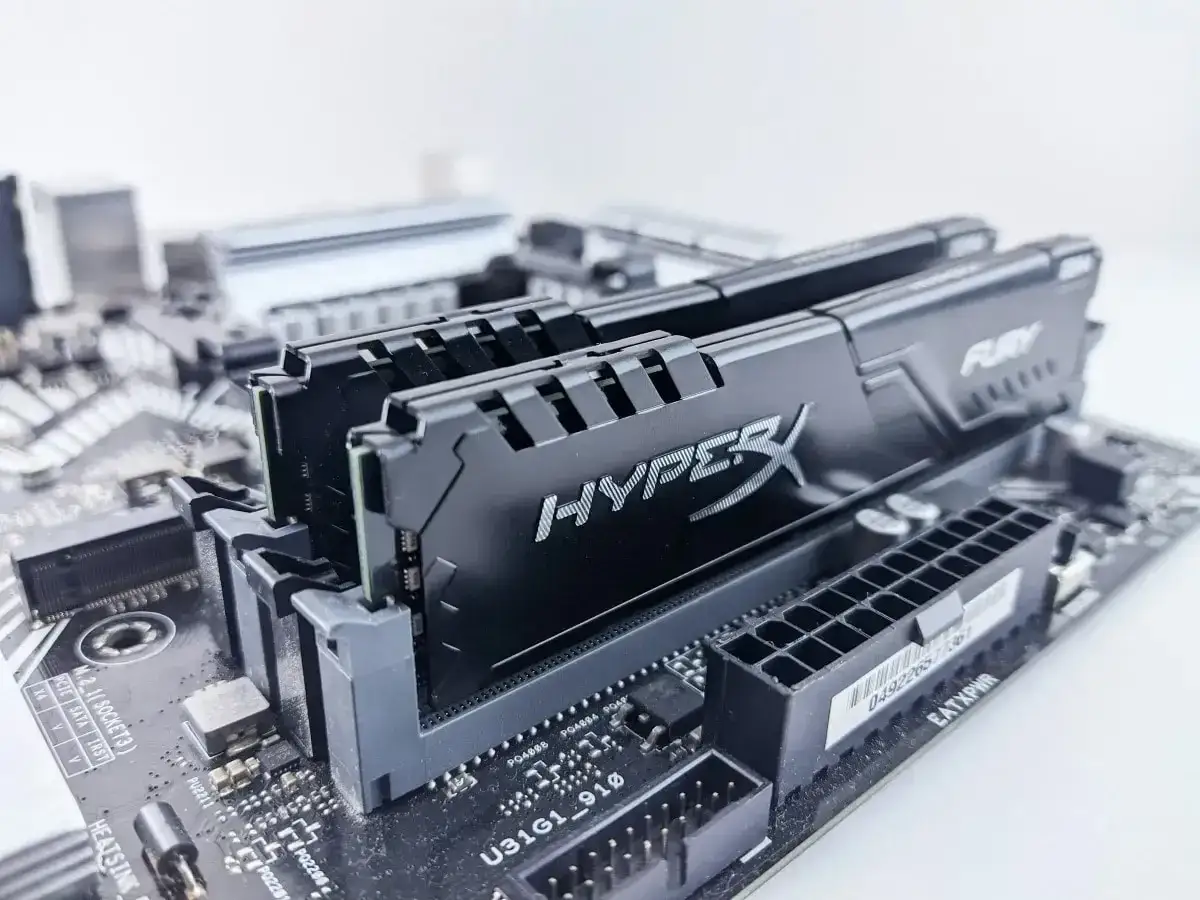 Deux barrettes de mémoire RAM HyperX Fury noires installées sur une carte mère.