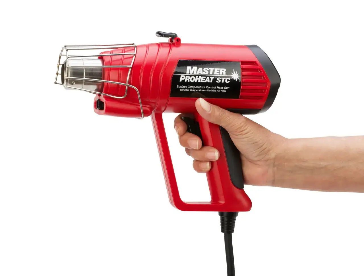 Main rouge tenant un décapeur thermique avec réglage de température. Idéal pour divers travaux.