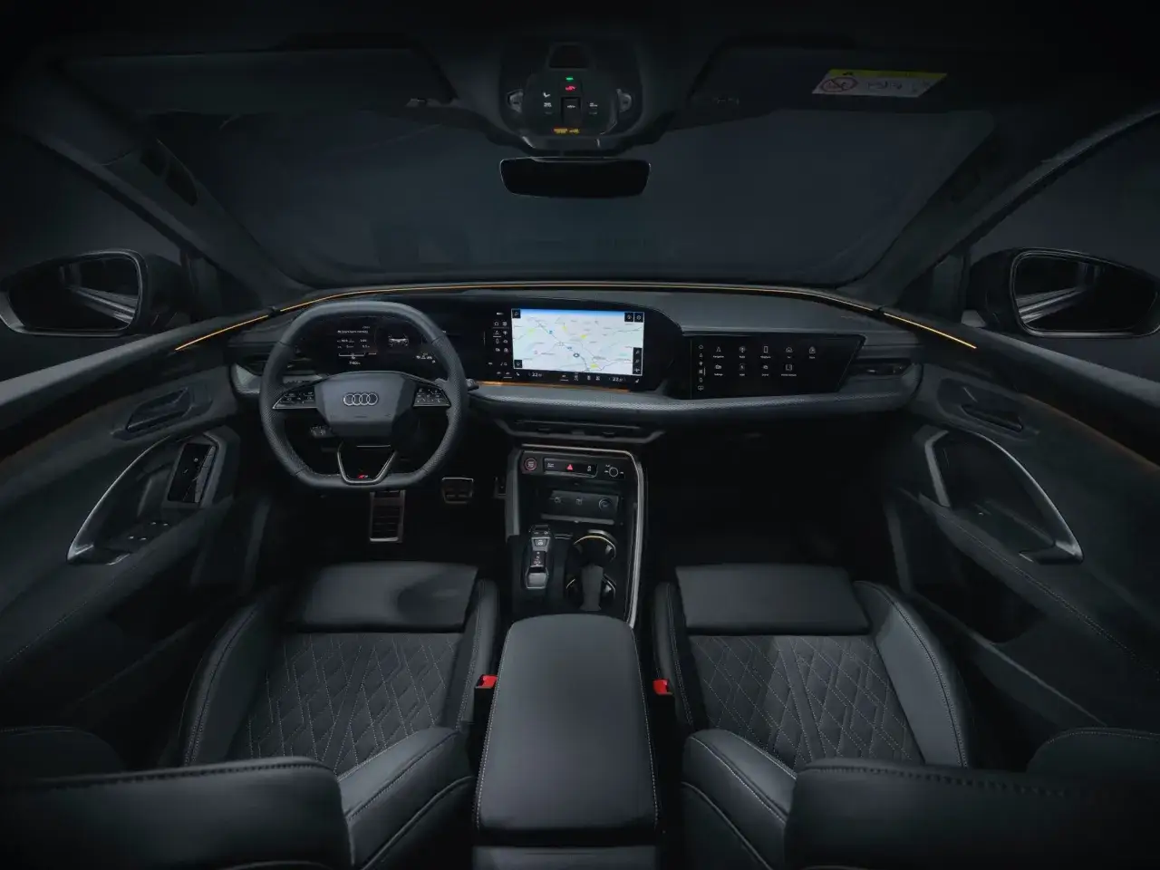 Wnętrze Audi Q5: skórzane fotele, nowoczesny kokpit z ekranem nawigacji i cyfrowymi zegarami. Wiele osób chwali sobie komfort i technologię, co potwierdzają liczne audi q5 opinie.
