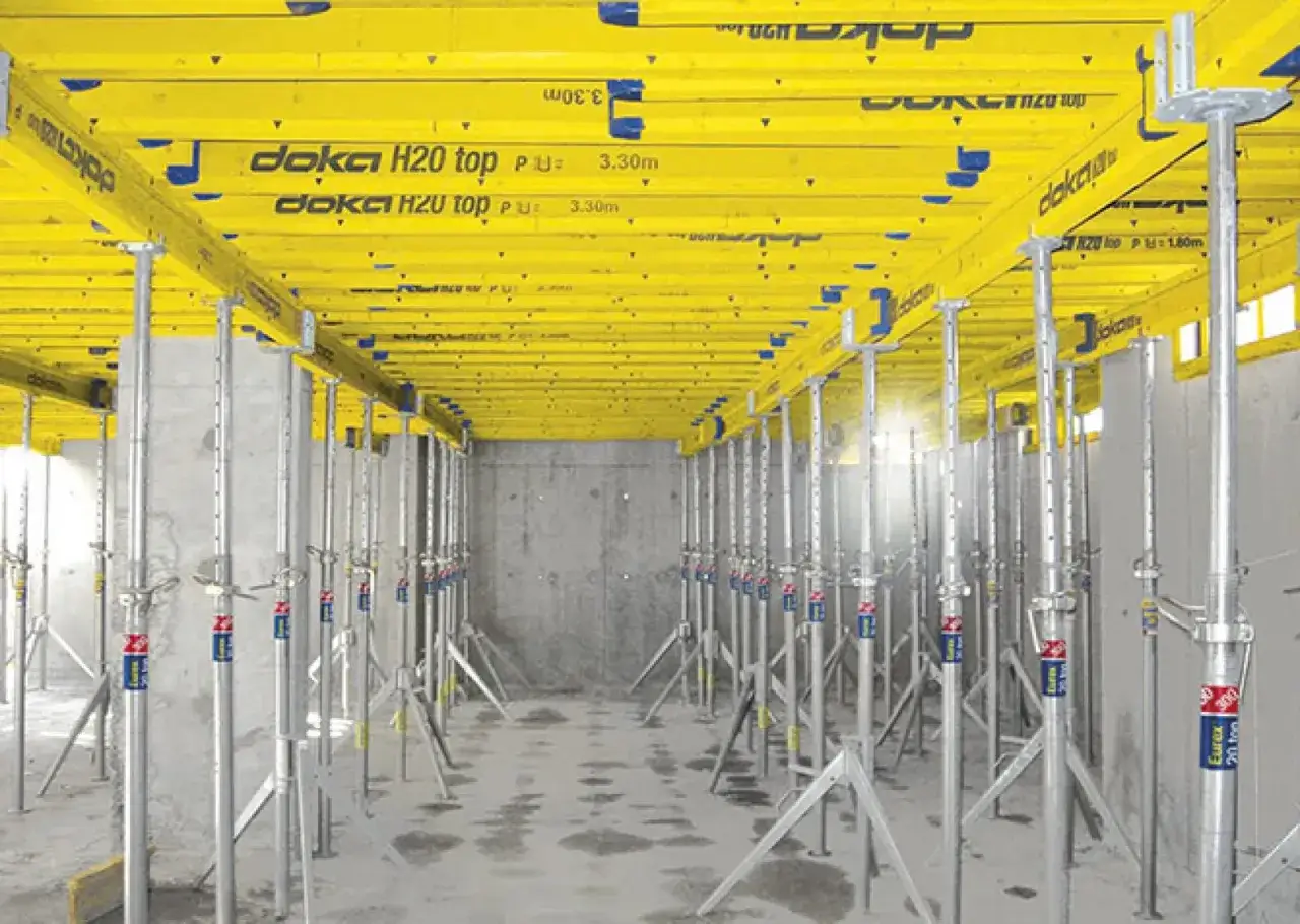 Estructura de encofrado amarillo con soportes met&aacute;licos, mostrando las partes de un apeo para sostener una losa.