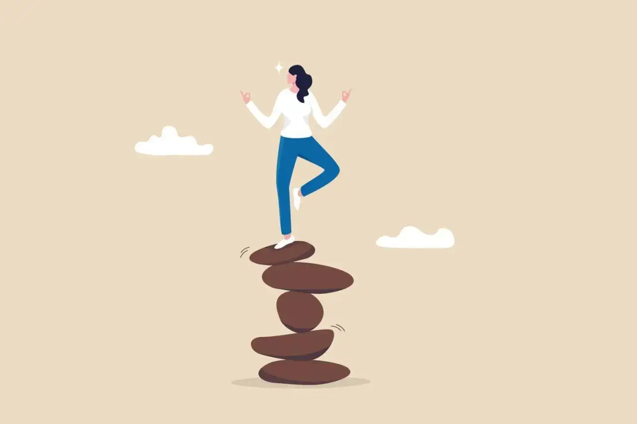 Mujer en equilibrio sobre piedras apiladas, meditando. Representa la b&uacute;squeda del dharma, el camino correcto.