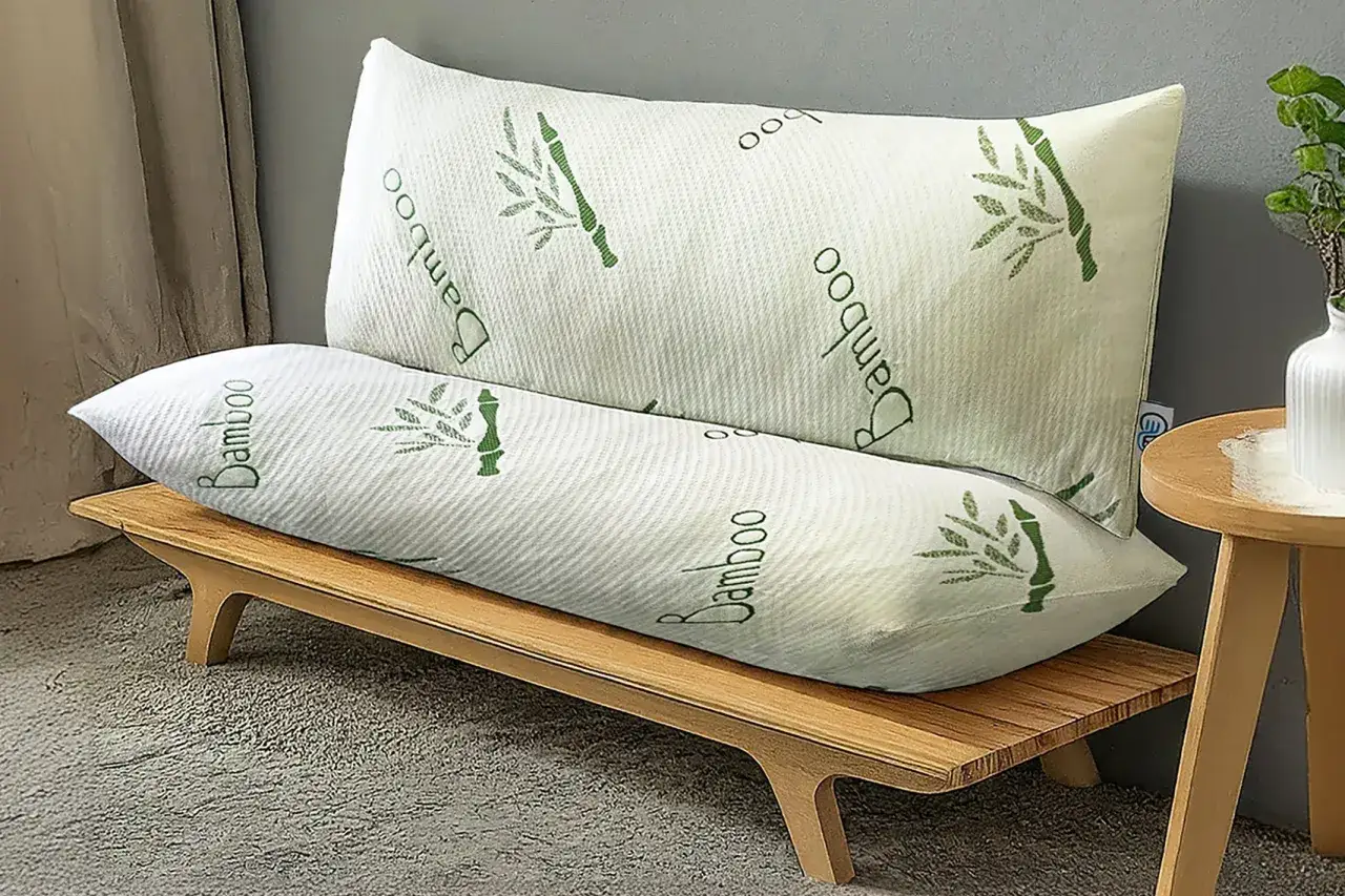 Two white bamboo pillows with green bamboo stalks and 