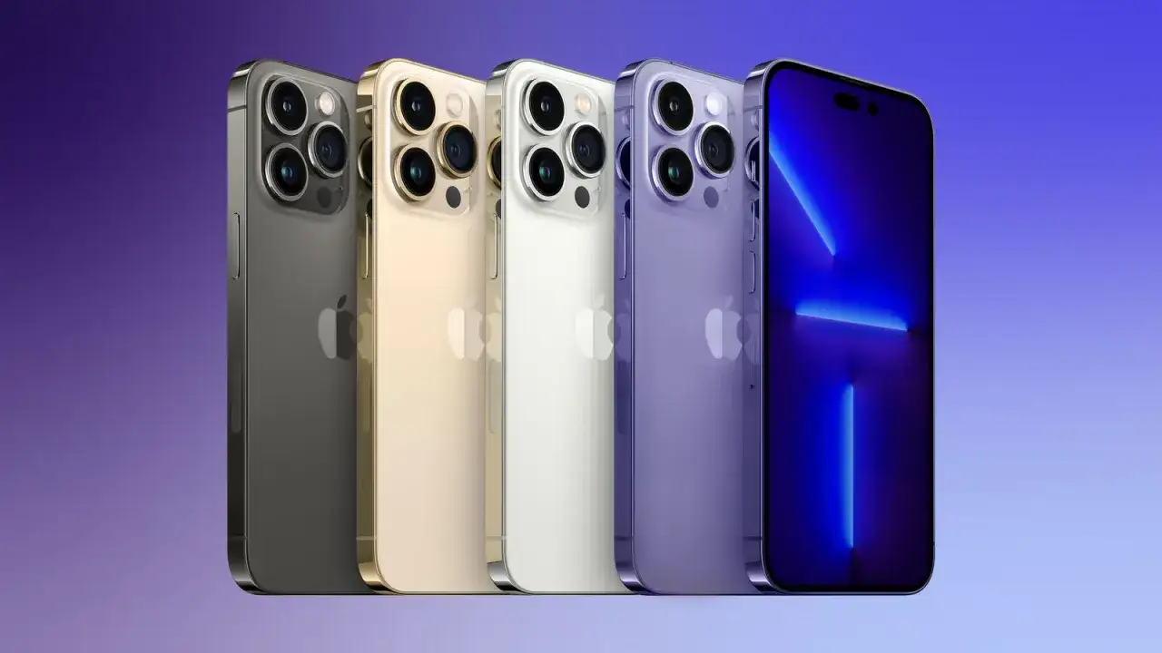 Pięć iPhone'ów 14 Pro w różnych kolorach: grafitowym, złotym, białym i fioletowym, prezentuje się na tle gradientu.