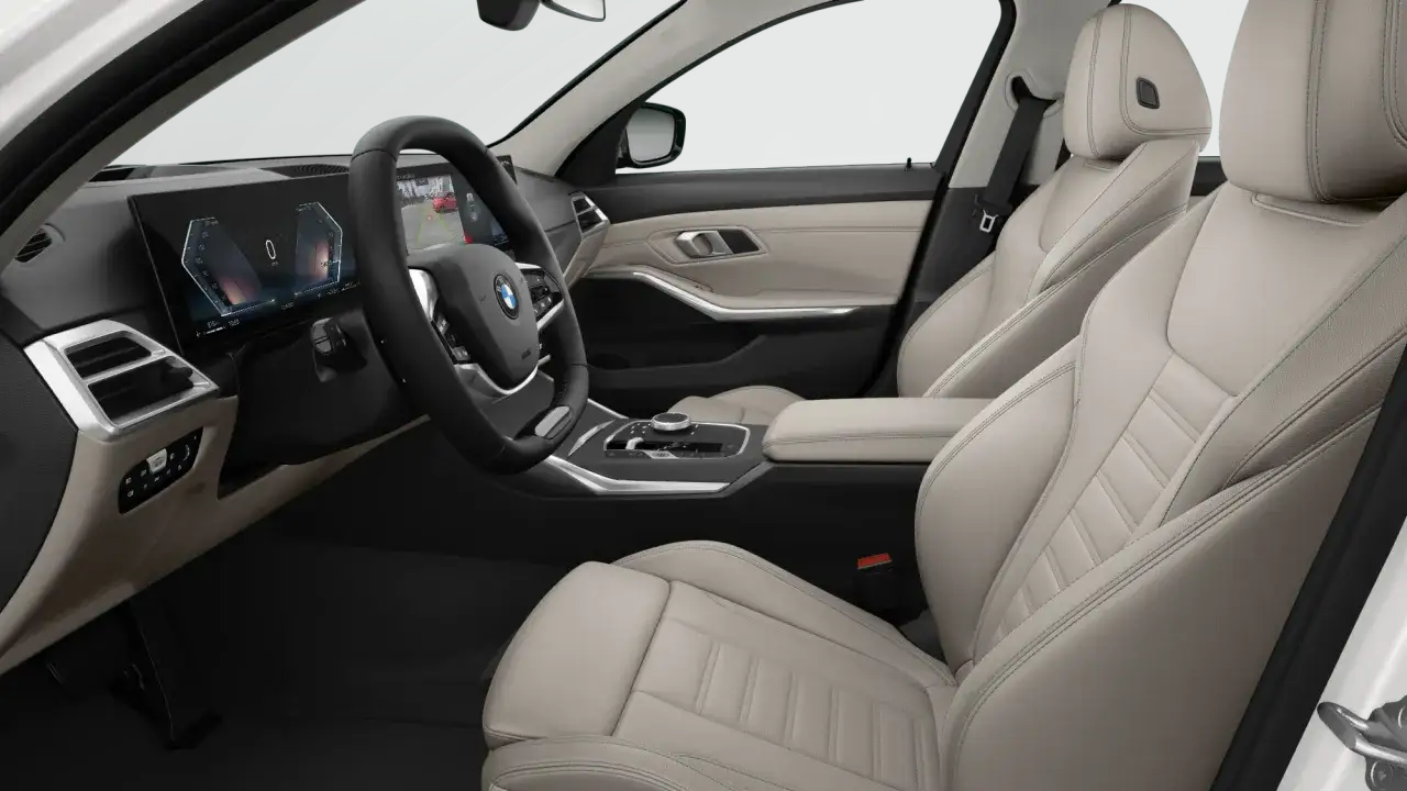 Wnętrze BMW 318d z jasną tapicerką, nowoczesnym kokpitem i ekranem multimedialnym.