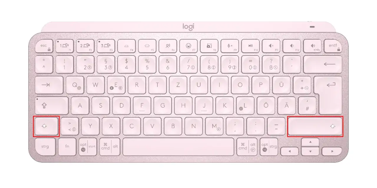 Teclado rosa con teclas resaltadas: la tecla Shift izquierda y la tecla Shift derecha.
