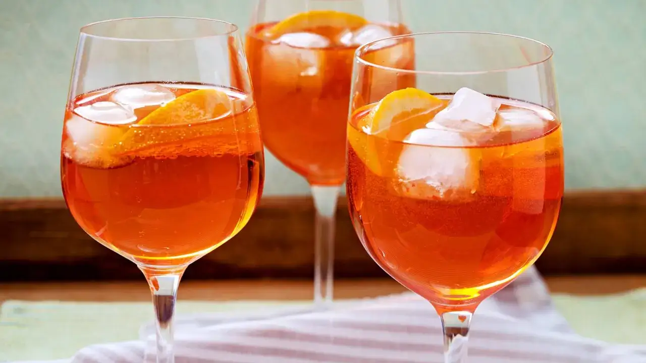 Drei Gl&auml;ser mit erfrischendem, alkoholfreiem Aperol, garniert mit Orangenscheiben und Eisw&uuml;rfeln.