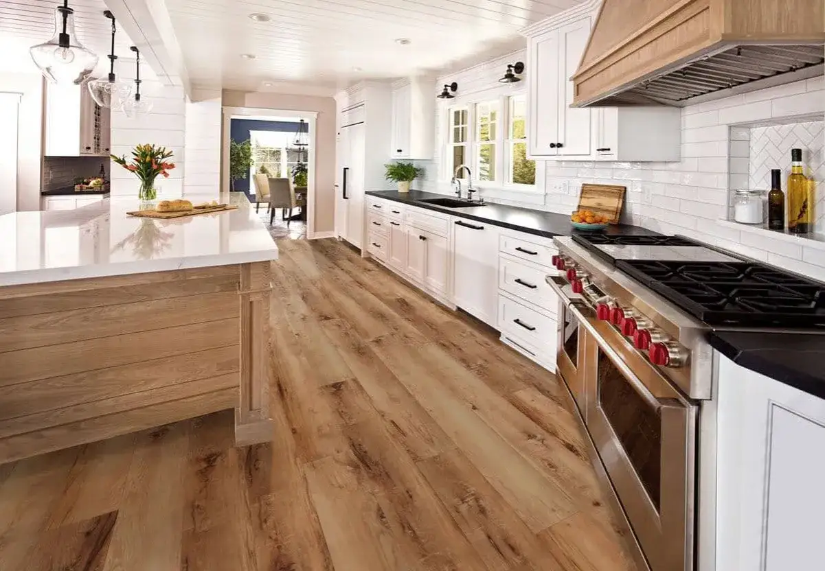 This beautiful kitchen features light wood vinyl plank flooring, perfect for walking on immediately after installation.