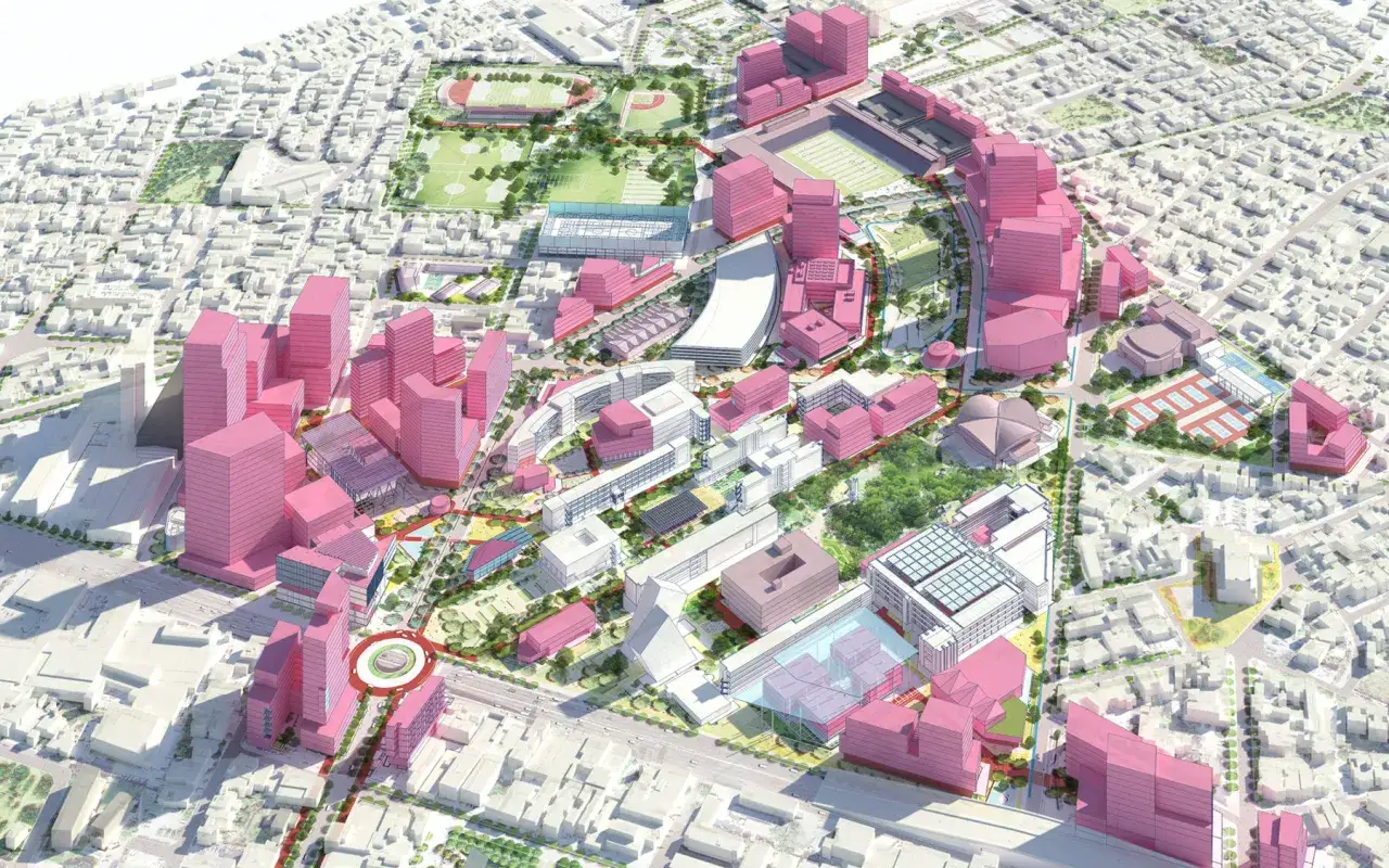 Diseño urbano moderno con edificios rosados y blancos, áreas verdes y un estadio. Un proyecto que busca la certificación BREEAM.