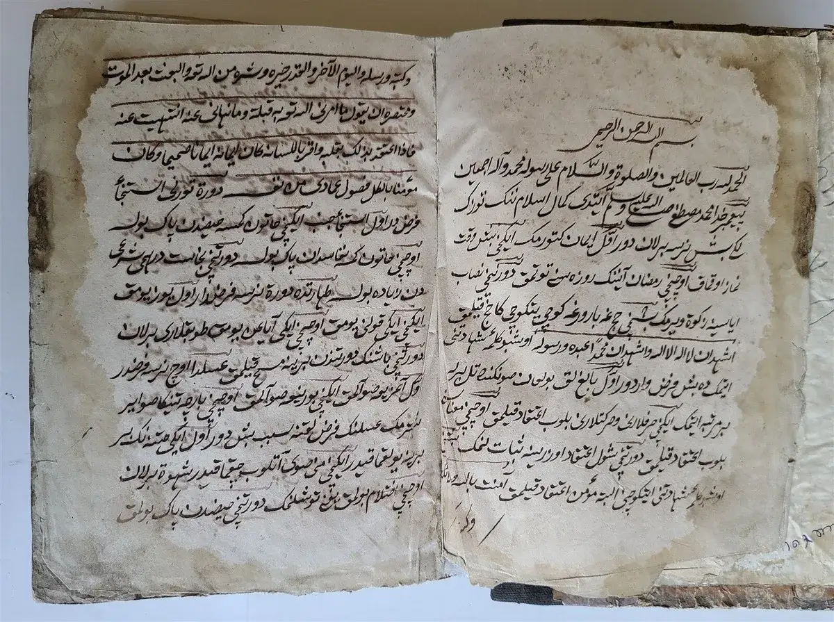 Altes Buch mit arabischen Gedichten, die in alter Schrift verfasst sind. Die Seiten sind vergilbt und besch&auml;digt, was dem Manuskript einen historischen Charme verleiht.