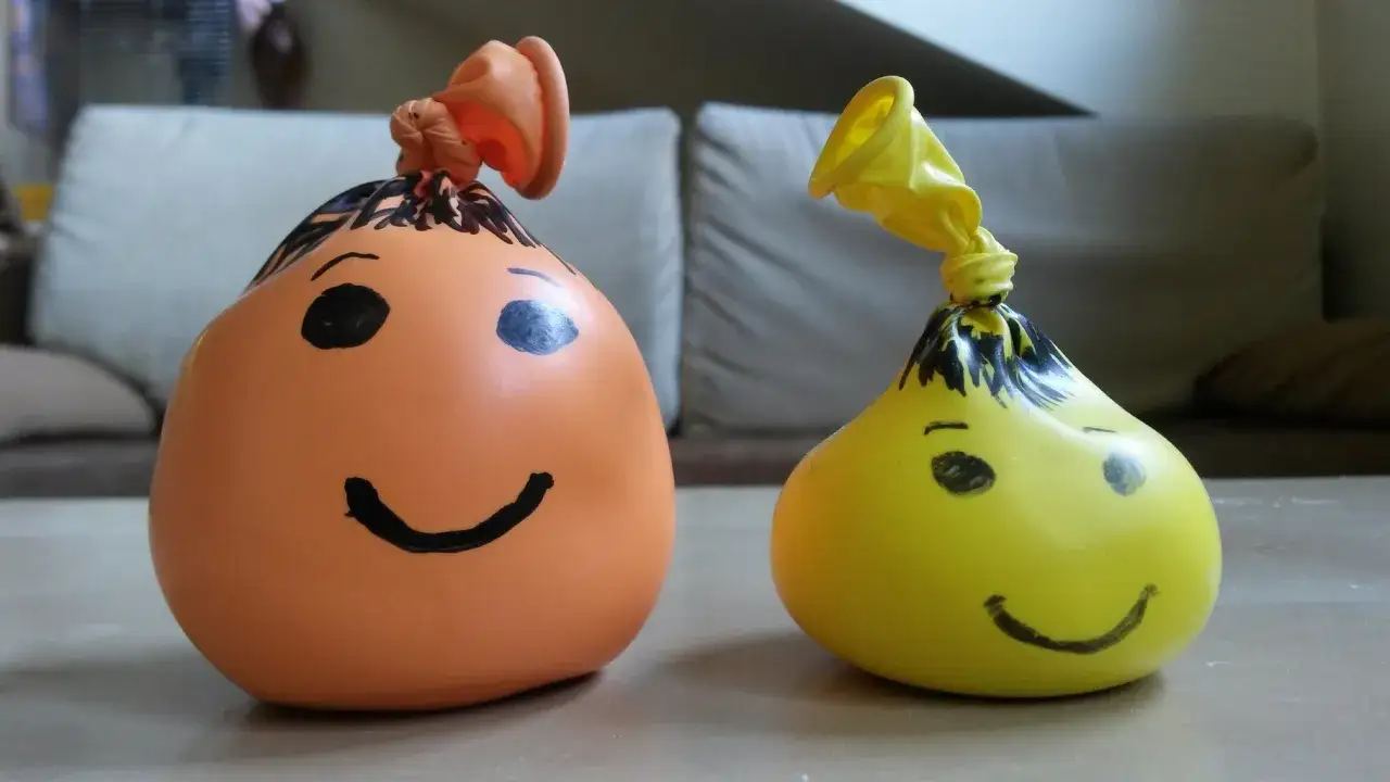Dwa balony z namalowanymi buźkami, jak zrobić gniotka z mąki i wody.