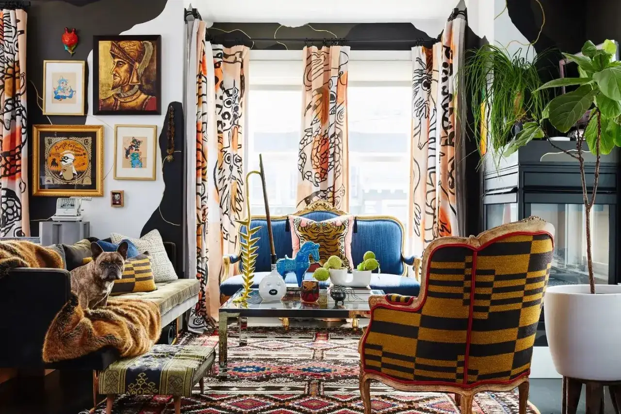 A French bulldog sits on a sofa in a vibrant living room, showcasing a bold mix of patterns on curtains, rugs, and furniture.