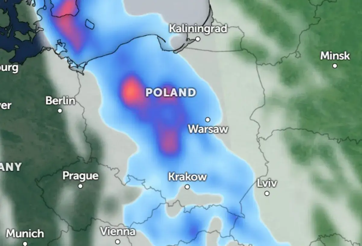 Chłodny front pogodowy nad Polską, z intensywnymi opadami śniegu zaznaczonymi na czerwono i niebiesko. Widoczne miasta: Warszawa, Kraków, Berlin, Kaliningrad, Mińsk.