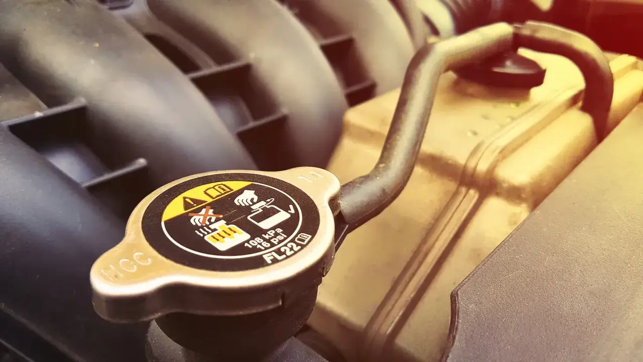 Radiator cap with warning symbols. A faulty cap can lead to overheating, a common symptom of bad radiator cap issues.