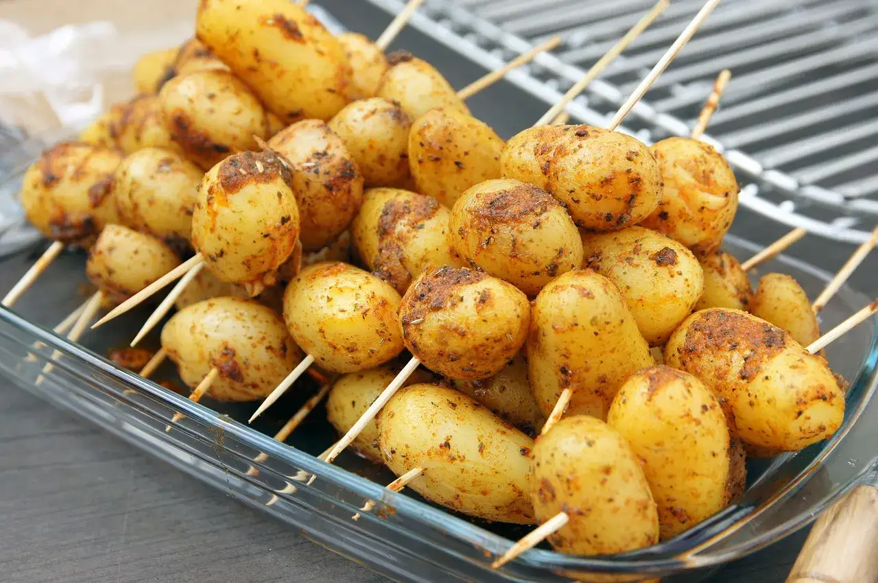 Brochettes de pommes de terre assaisonn&eacute;es, pr&ecirc;tes pour le barbecue. Un d&eacute;lice croustillant en perspective !