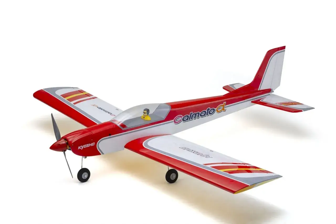 Ein rotes und weißes RC-Flugzeugmodell mit Pilot im Cockpit. Dieses phönix modellbau ist bereit für den Start.