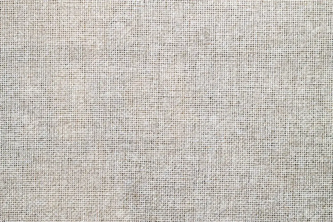 Texture d'un tissu en fibre naturelle, un tissage grossier et authentique.