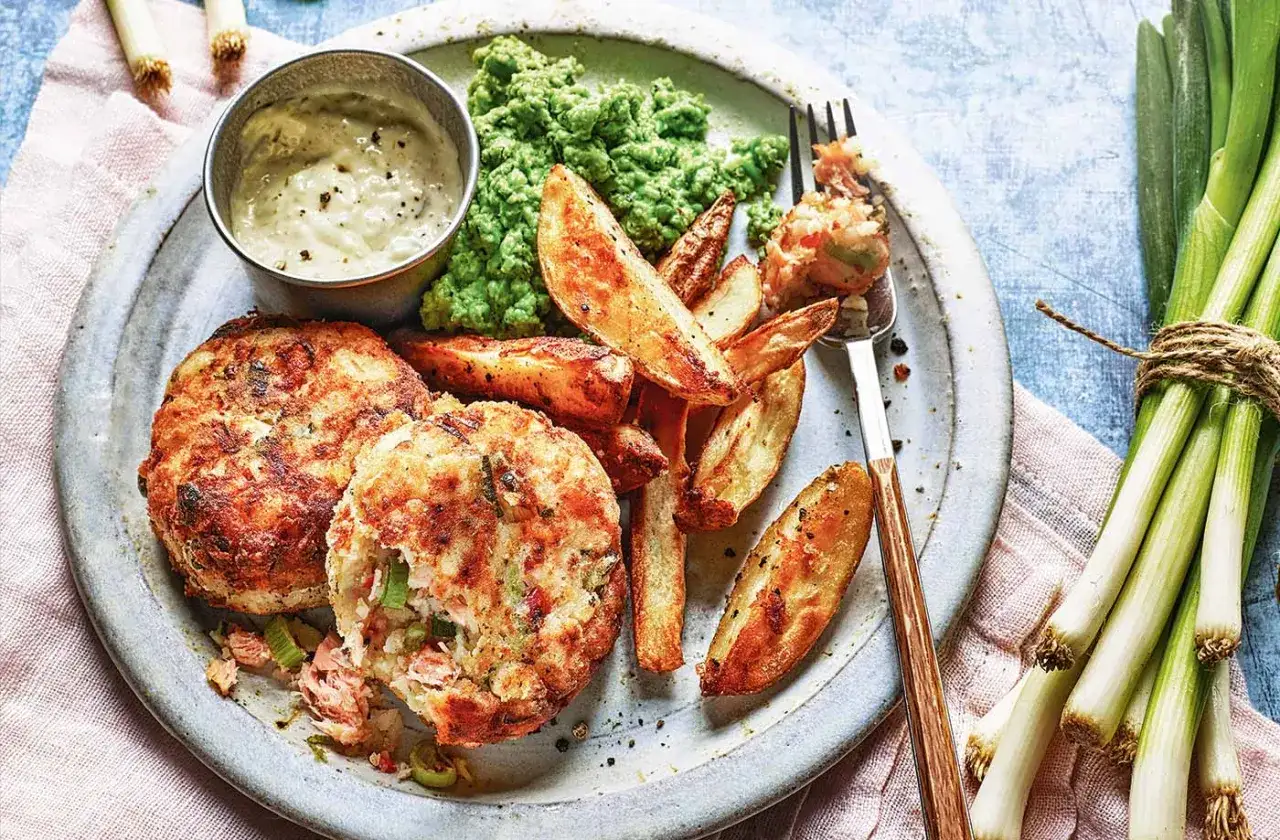 Fish cakes with crispy potato wedges, mushy peas, and a dipping sauce. Imagine these served with a side of chikuwa tempura for a delightful meal.