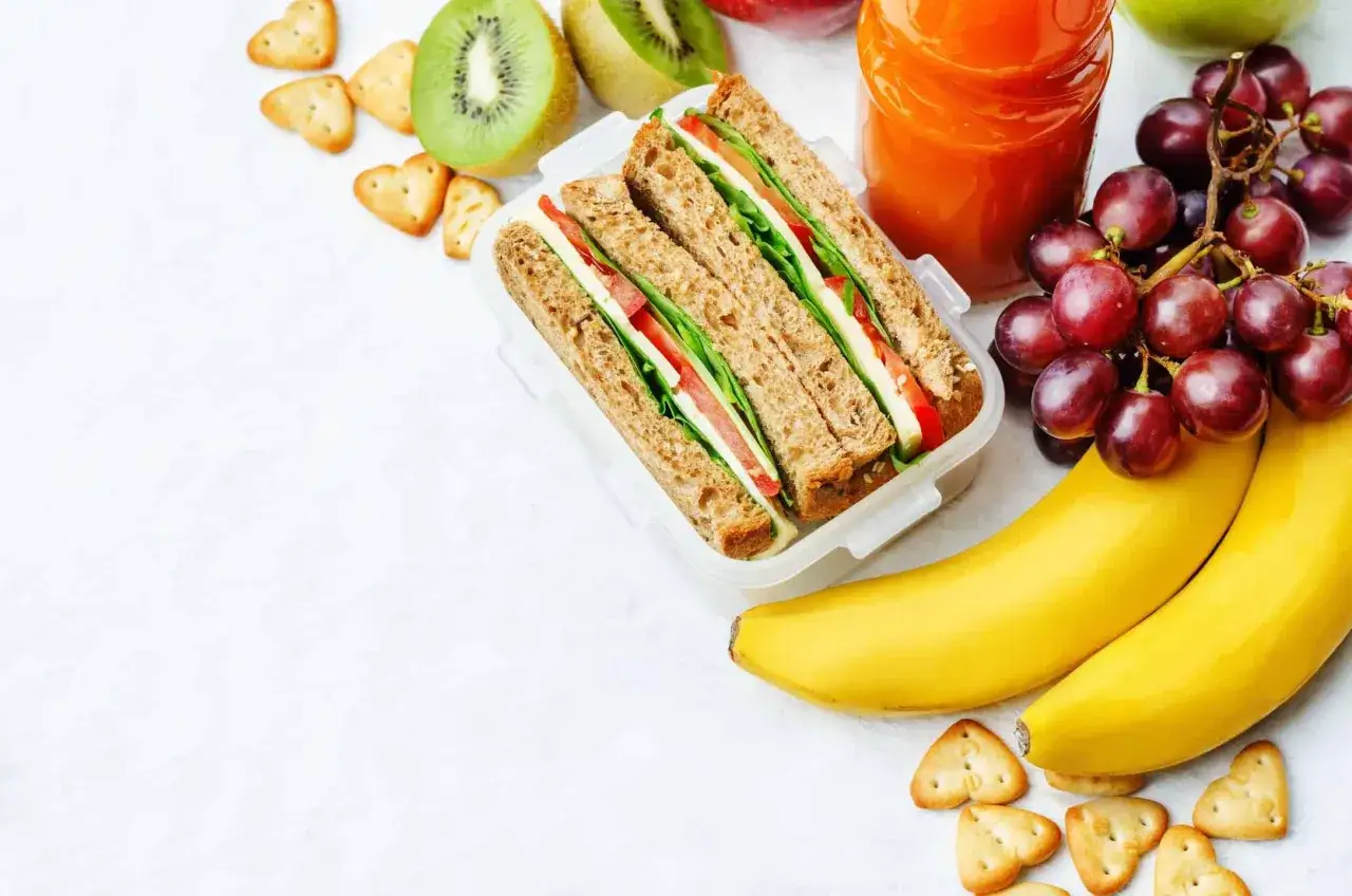Zdrowy lunchbox z kanapką, owocami i sokiem, idealny na dietę 1800 kcal.