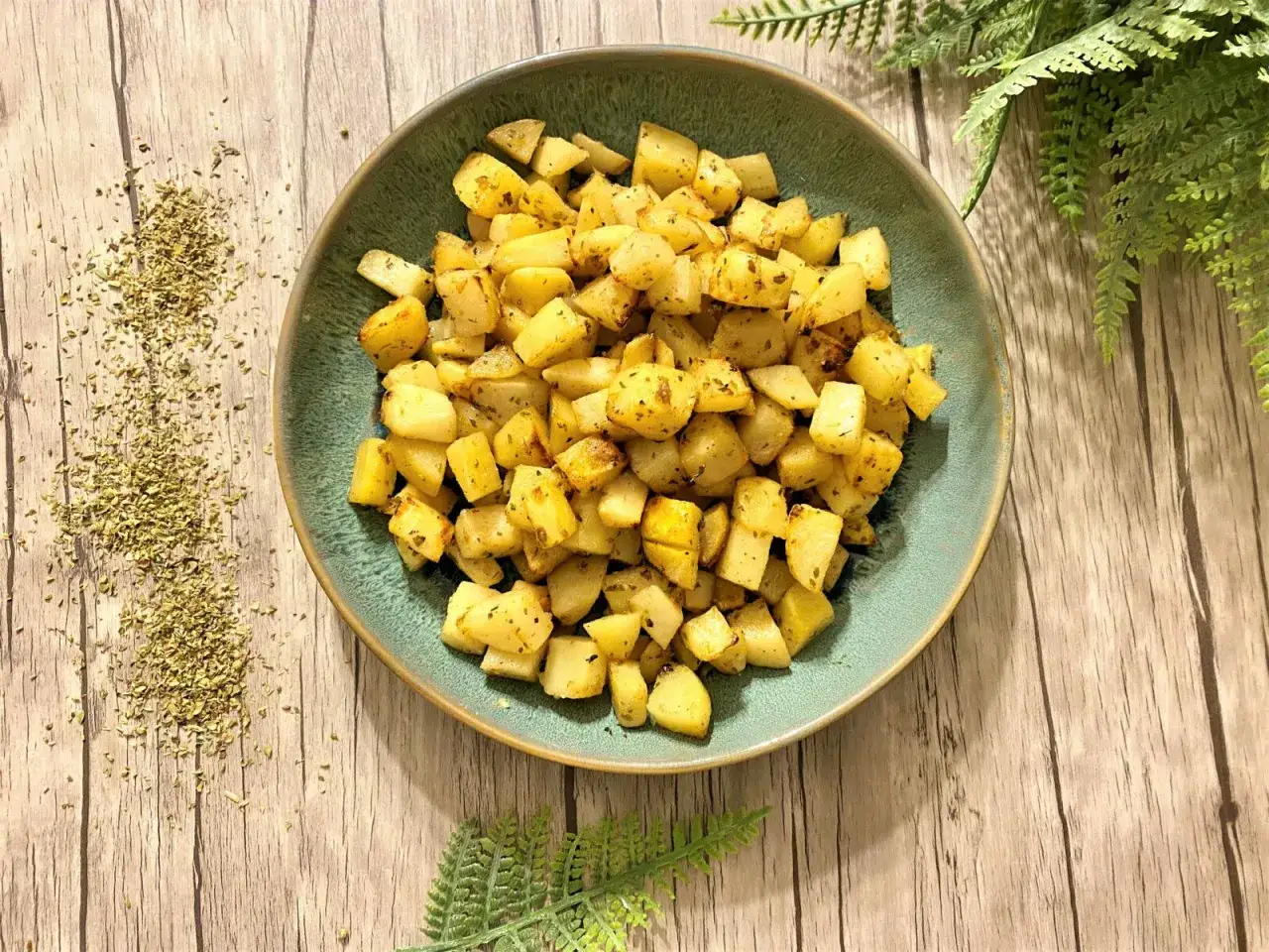 Assiette de pommes de terre rôties aux herbes, parfaites pour une recette simple et savoureuse.