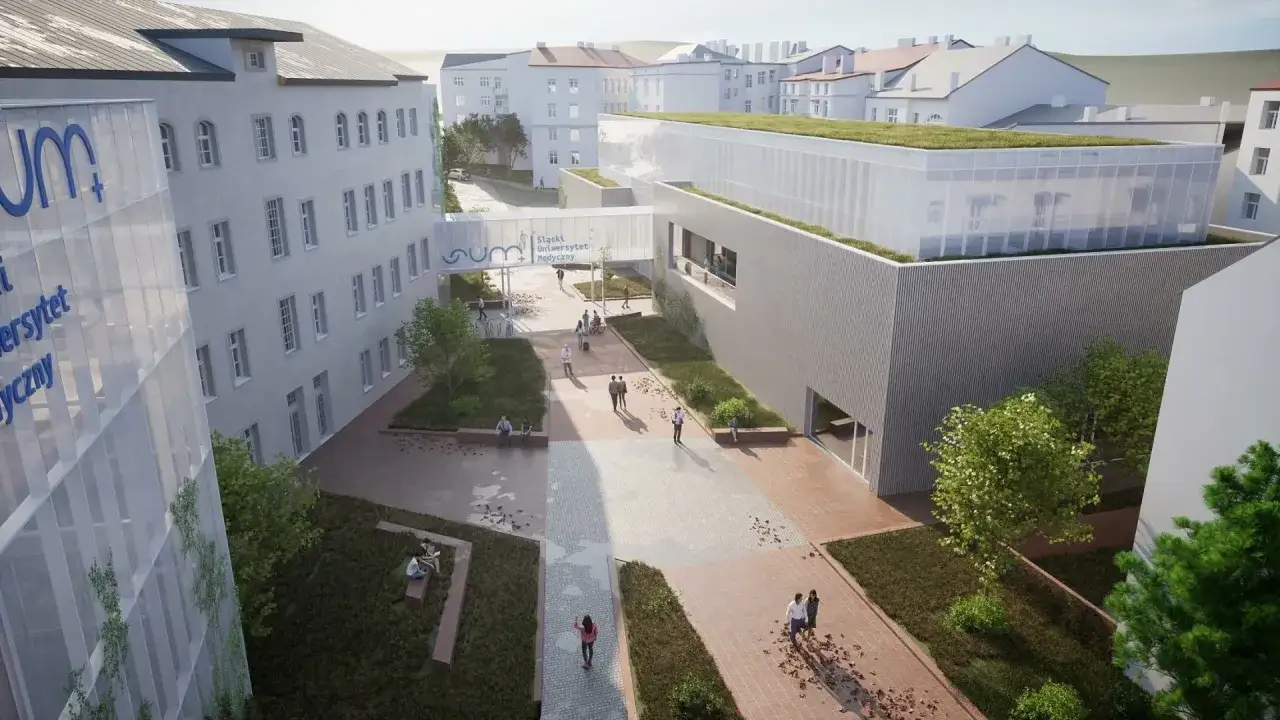 Nowoczesne budynki uczelni w Bielsku-Białej, z zielonym dachem i łącznikiem. Studenci spacerują po dziedzińcu.