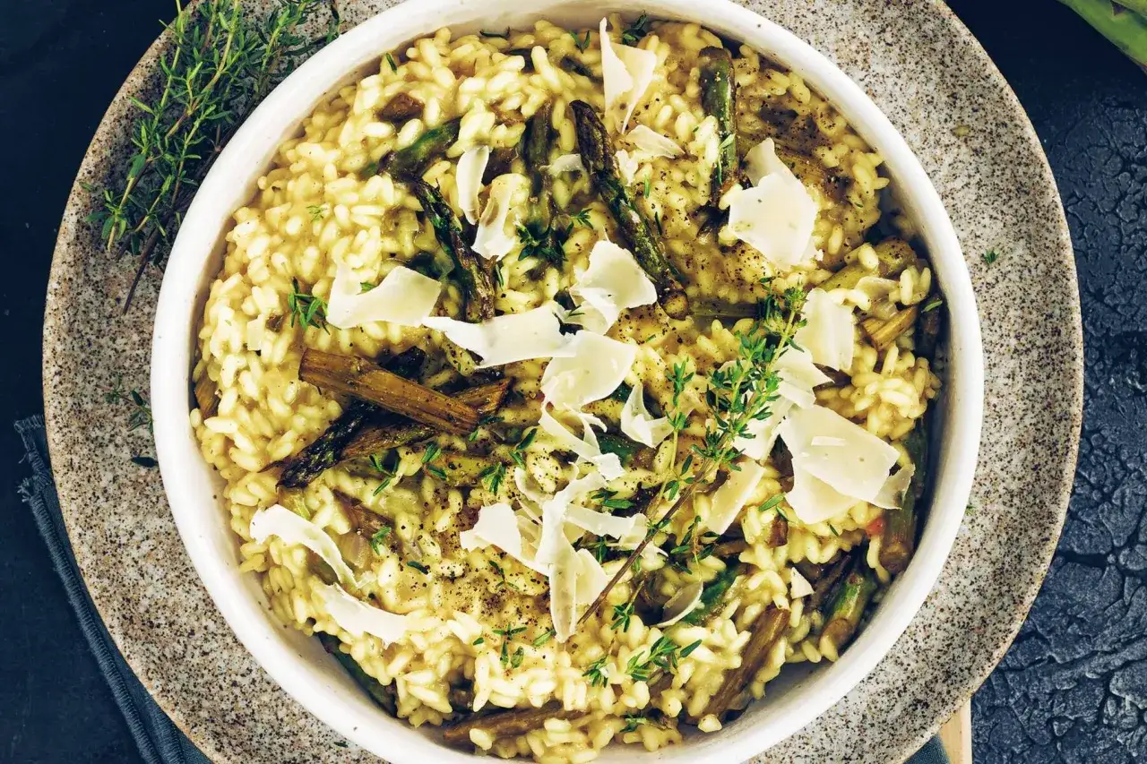 Cremiges Risotto mit Spargel, garniert mit Parmesan und frischem Thymian. Ein Genuss für alle Sinne.