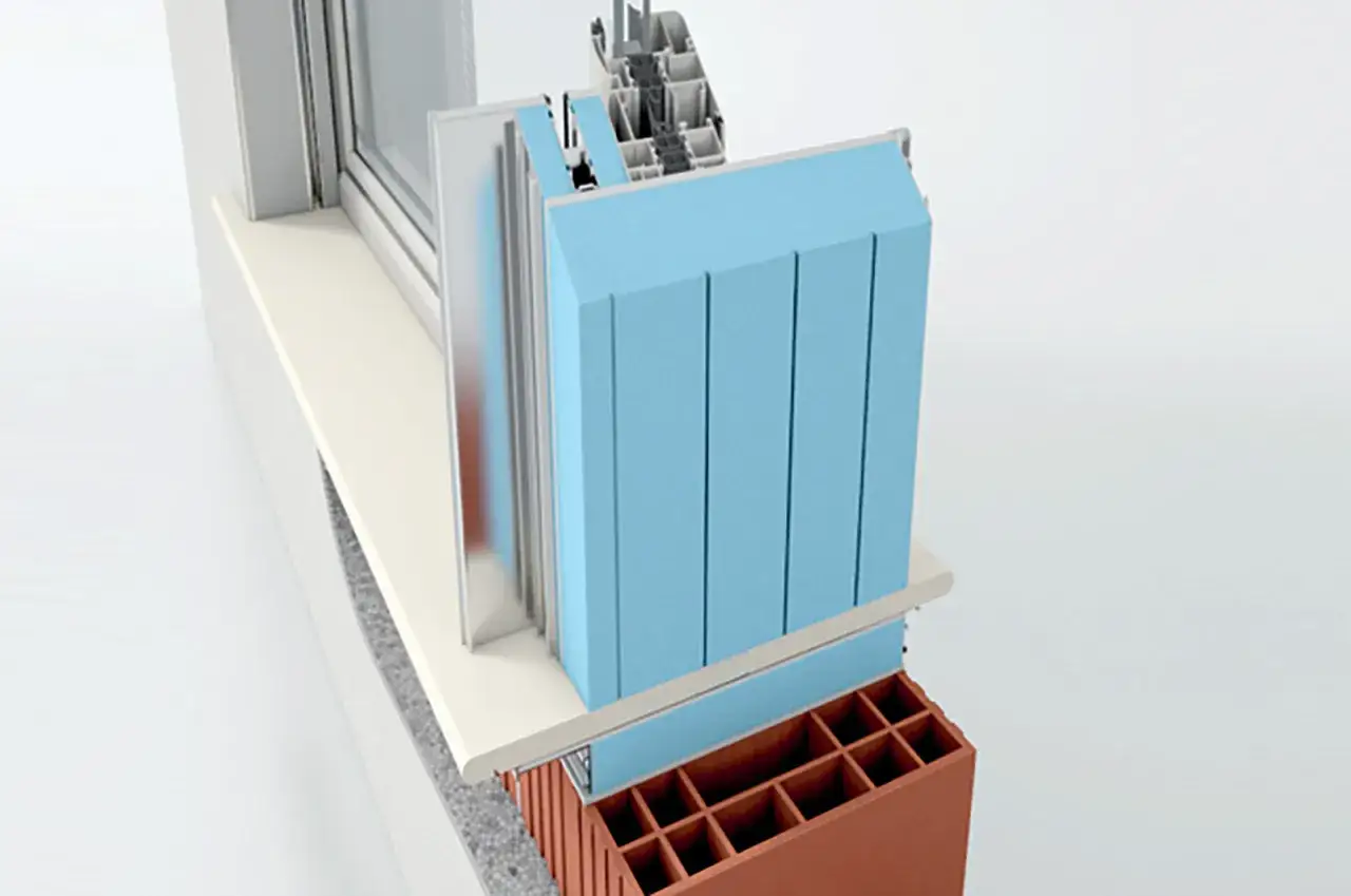 Sezione di una finestra con spallette isolate in blu, mostrando la struttura interna e i materiali isolanti.