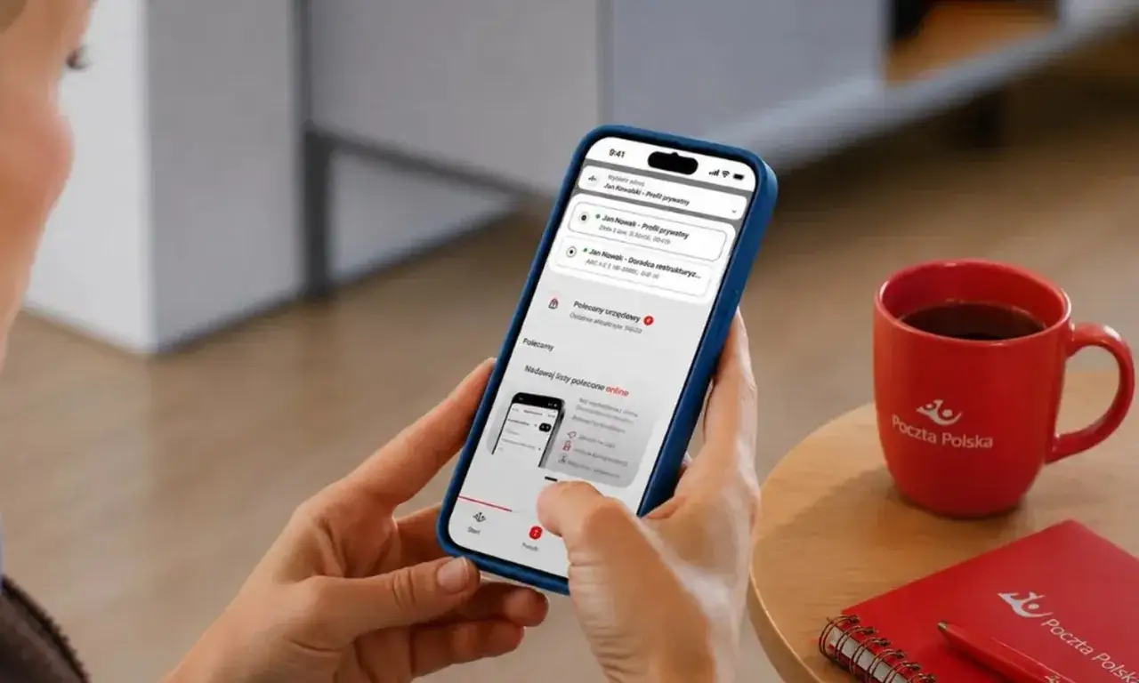 Aplikacja Poczty Polskiej na telefonie pokazuje, czy można odebrać list polecony na poczcie bez okazania awizo. Obok kubek z logo Poczty Polskiej.
