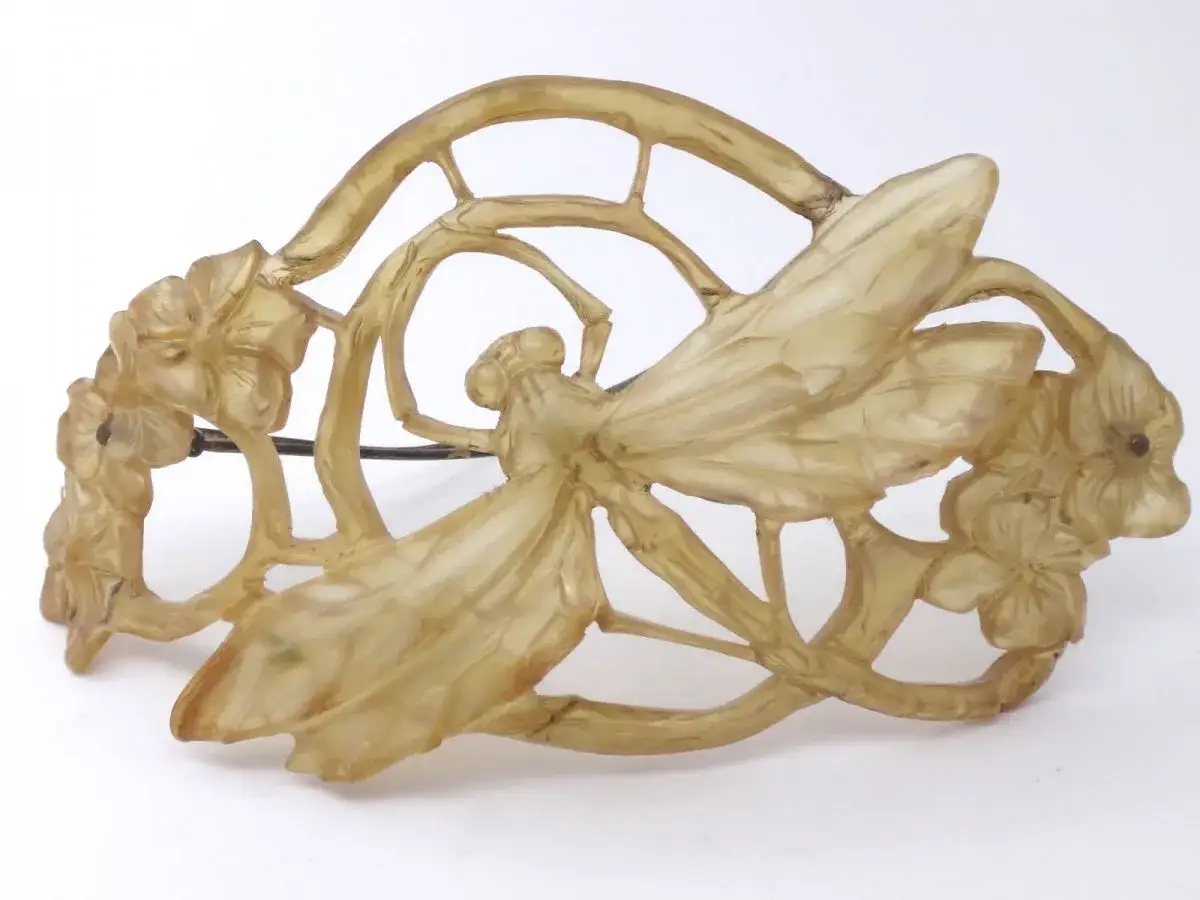 Broche en corne sculptée par Lucien Gaillard, représentant une libellule sur des fleurs stylisées. Art nouveau.