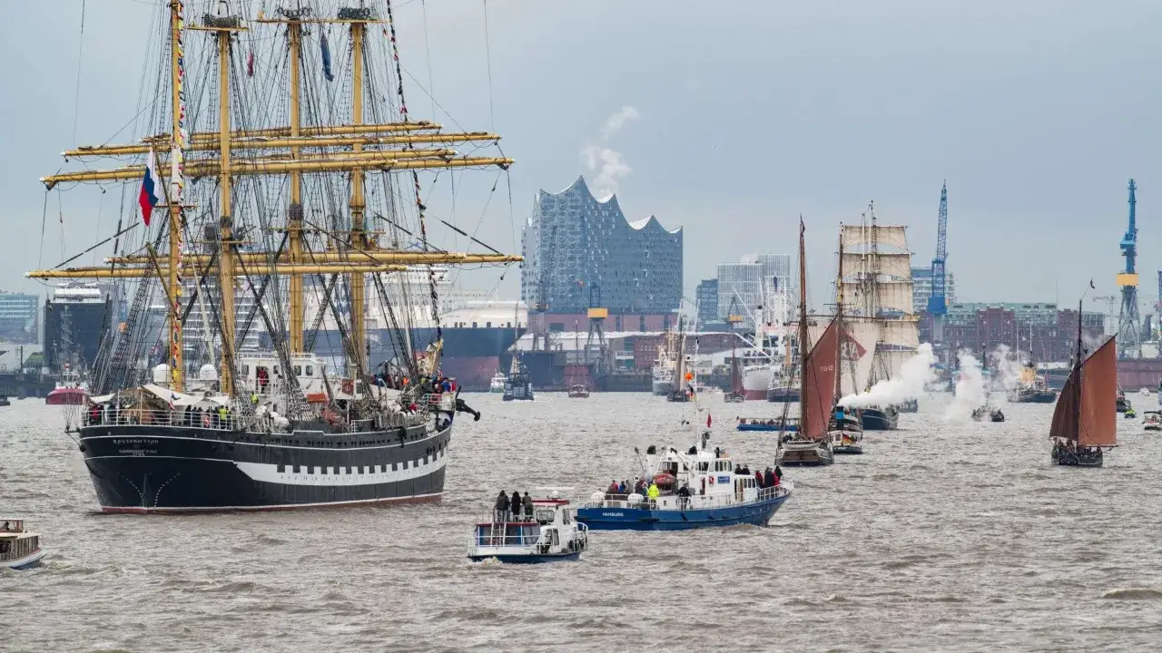 Gro&szlig;e Segelschiffe und Boote nehmen an der einlaufparade hafengeburtstag teil, mit der Elbphilharmonie im Hintergrund.