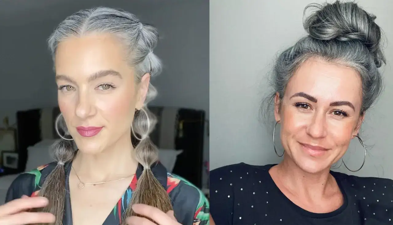 Dos mujeres con cabello gris natural. Una con coletas burbuja y la otra con un moño alto. Ellas muestran que porque salen las canas es parte de la belleza.