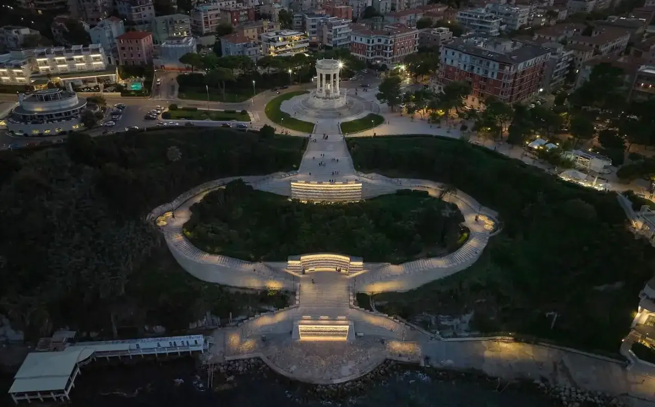 Scalinate illuminate conducono al monumento in cima alla collina, con la citt&agrave; e il mare sullo sfondo. La spiaggia del Passetto &egrave; un luogo magico di sera.