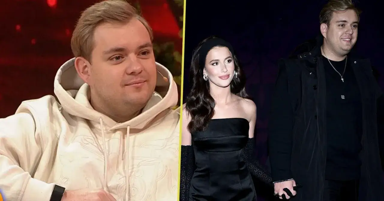 Kevin Mglej, niczym dziecko, patrzy w stronę kamery. Obok niego jego partnerka w czarnej sukni i rękawiczkach.
