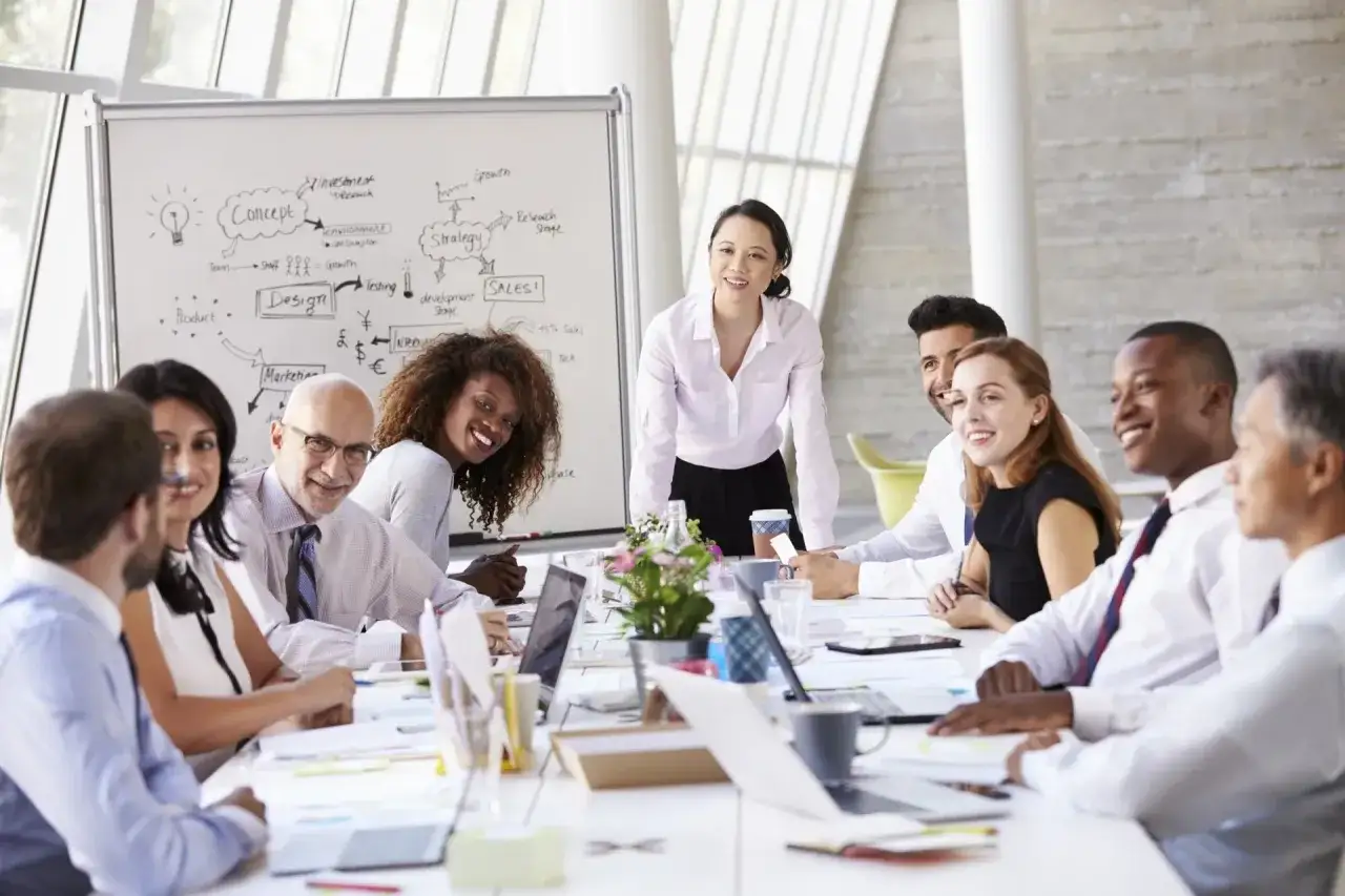 Diverse team in a meeting, discussing strategy and sales. This highlights why performance reviews are important for growth and development.